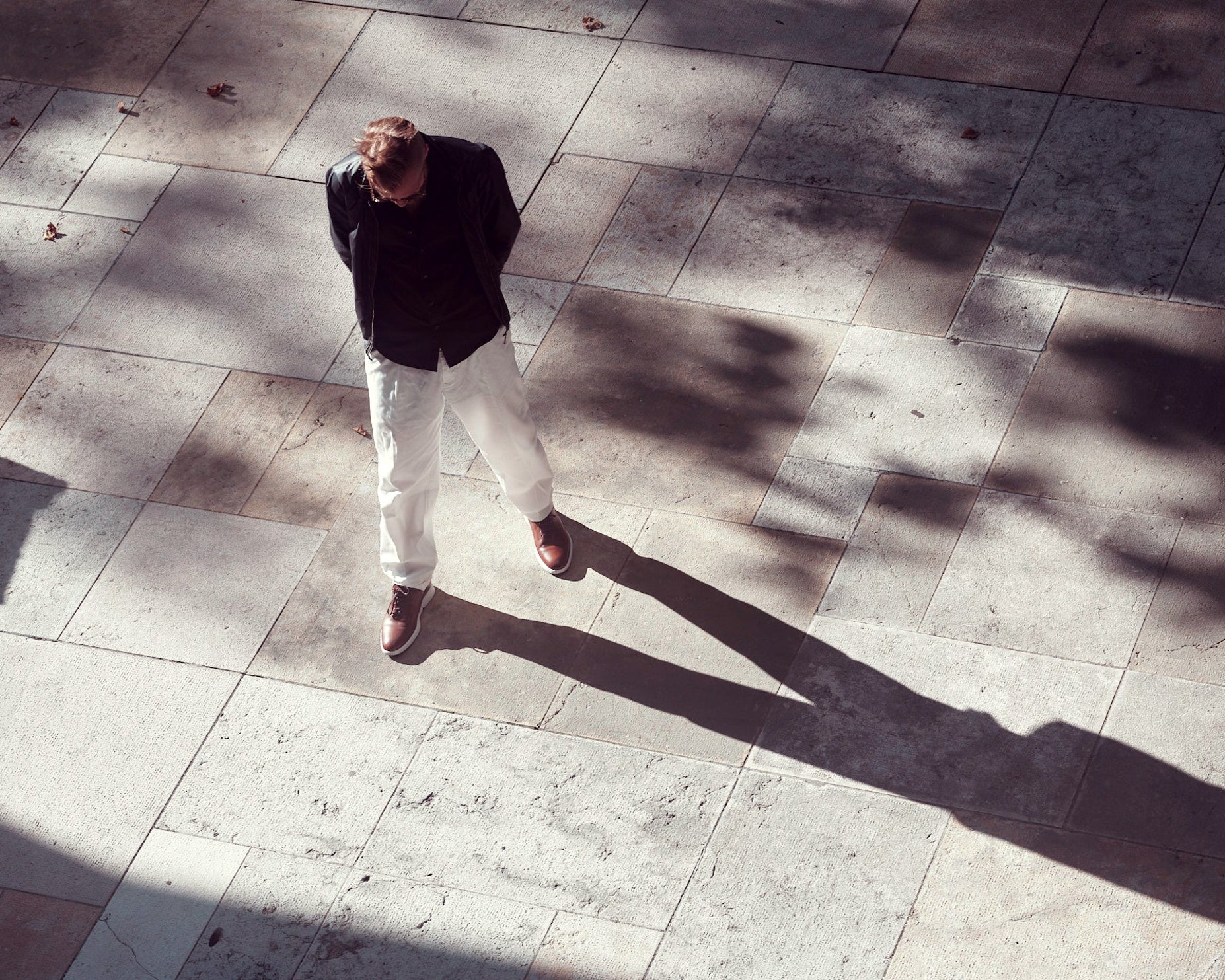 Top-down photo of model wearing RONIN in tan on street. KANREY derby shoes in tan.
